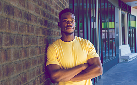 Man leaning against a wall